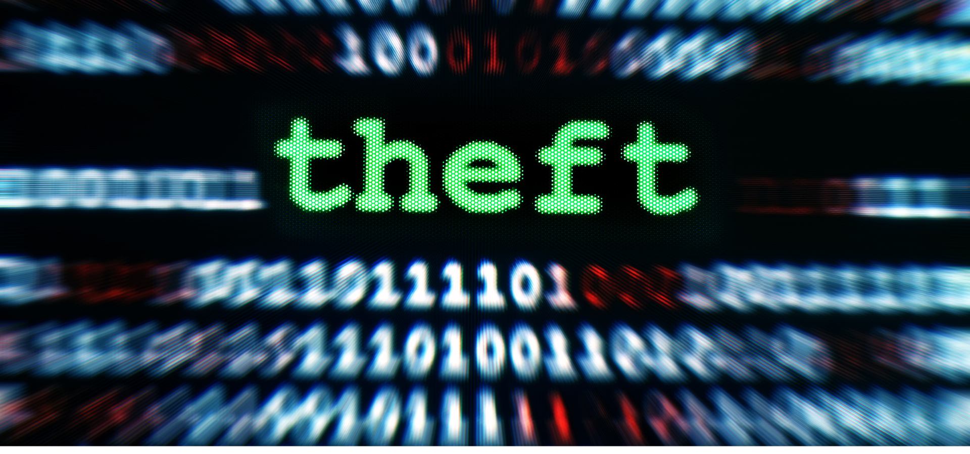 blurry computer codes with the word theft across them