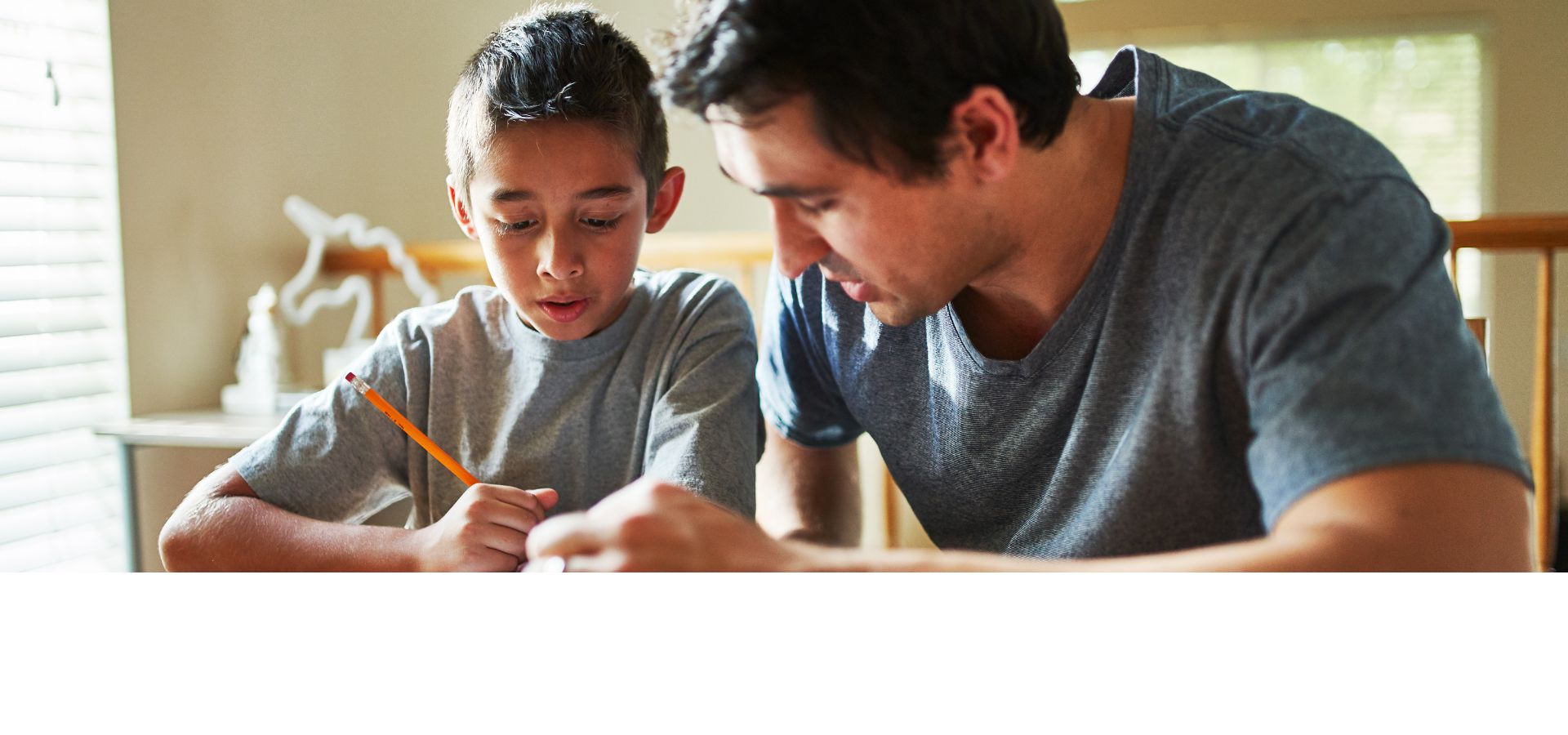 father explaining school work to son