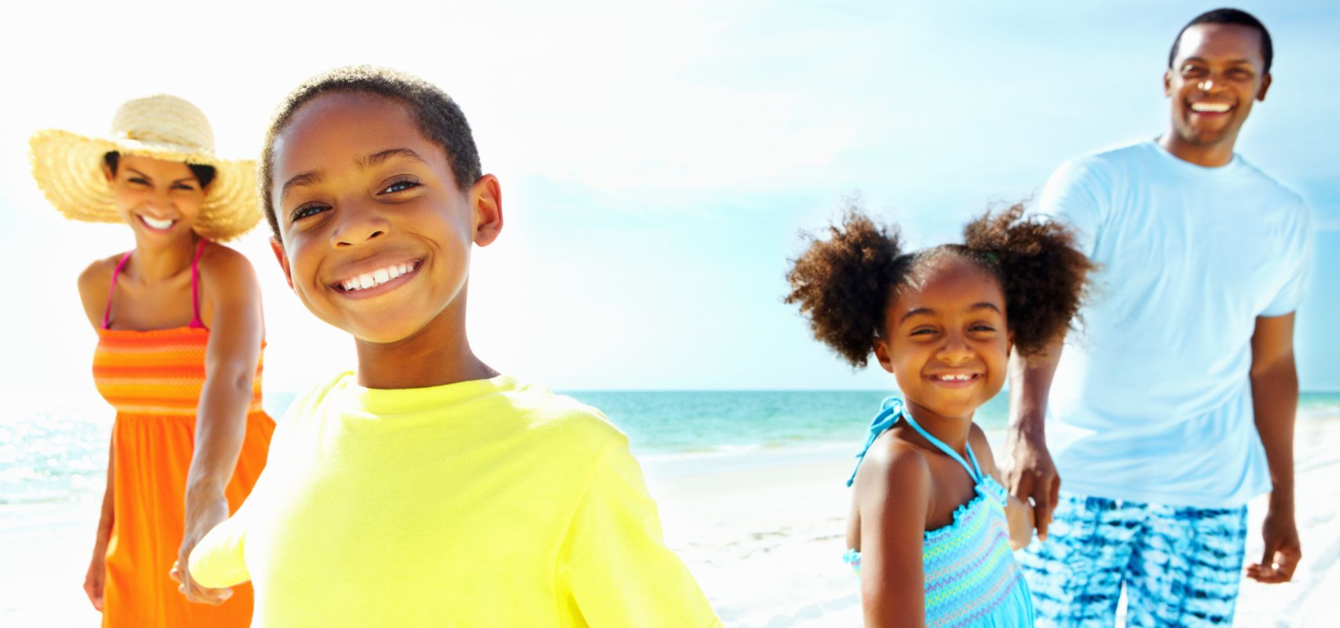 family of 4 playing on beach