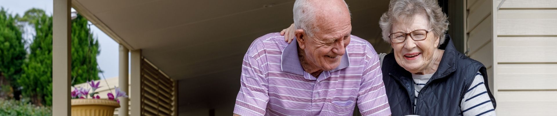senior couple enjoying coffee on porch